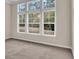 Bright bedroom featuring three large windows with views of the outdoors at 489 Rose Fountain Dr., Myrtle Beach, SC 29579