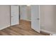 Bright bedroom with hardwood floors and white doors leading to other rooms at 489 Rose Fountain Dr., Myrtle Beach, SC 29579