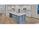 Elegant kitchen with white cabinets, backsplash, stainless steel appliances, and large center island at 489 Rose Fountain Dr., Myrtle Beach, SC 29579