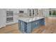 Modern kitchen with a large blue island, white cabinets, and stainless steel appliances at 489 Rose Fountain Dr., Myrtle Beach, SC 29579