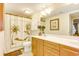 Inviting bathroom featuring shower with decorative curtain, toilet, and wood cabinets at 502 48Th Ave. S # 402, North Myrtle Beach, SC 29582