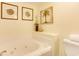 Relaxing bathroom featuring a soaking tub, neutral color scheme, and tile accents, offering a spa-like experience at 502 48Th Ave. S # 402, North Myrtle Beach, SC 29582