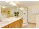 Bathroom featuring double sinks, wood cabinets, and a glass-enclosed shower, offering a functional and stylish space at 502 48Th Ave. S # 402, North Myrtle Beach, SC 29582