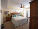 Comfortable bedroom with a woven headboard, a ceiling fan, and ample natural light creating a relaxing ambiance at 502 48Th Ave. S # 402, North Myrtle Beach, SC 29582