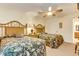 This bedroom features 2 beds, tropical bedding, a ceiling fan, and a doorway leading to the bathroom at 502 48Th Ave. S # 402, North Myrtle Beach, SC 29582
