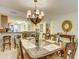 Elegant dining room with a chandelier and seating for six, perfect for entertaining guests at 502 48Th Ave. S # 402, North Myrtle Beach, SC 29582