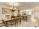 Dining area adjacent to kitchen with a chandelier over table and counter with bar stool seating at 502 48Th Ave. S # 402, North Myrtle Beach, SC 29582