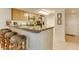 Kitchen featuring granite countertops, wood cabinets, stainless steel appliances, and breakfast bar with stool seating at 502 48Th Ave. S # 402, North Myrtle Beach, SC 29582