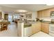 Open-concept kitchen with granite countertops, stainless steel appliances, and a view of the adjacent dining and living area at 502 48Th Ave. S # 402, North Myrtle Beach, SC 29582