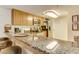 This kitchen features a breakfast bar with granite countertop, wood cabinets, and modern stainless-steel appliances at 502 48Th Ave. S # 402, North Myrtle Beach, SC 29582