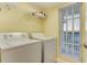 Convenient laundry room is equipped with a washer, dryer, and shelving for storage at 502 48Th Ave. S # 402, North Myrtle Beach, SC 29582