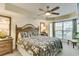 Comfortable main bedroom with a ceiling fan, plenty of natural light, and stylish furnishings at 502 48Th Ave. S # 402, North Myrtle Beach, SC 29582
