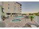 Relaxing pool area features a jacuzzi, in-ground pool, multiple tables and lounge chairs at 502 48Th Ave. S # 402, North Myrtle Beach, SC 29582