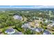 Aerial view of community surrounded by lush trees, a golf course, and a small lake at 5026 Belleglen Ct. # 101, Myrtle Beach, SC 29579