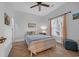 Cozy bedroom with stylish wood-look flooring, a ceiling fan, and natural light at 5026 Belleglen Ct. # 101, Myrtle Beach, SC 29579