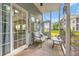 Cozy screened-in porch with comfortable seating and views of the landscaped backyard at 5026 Belleglen Ct. # 101, Myrtle Beach, SC 29579