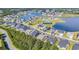 Aerial neighborhood view features a lake, pool, tennis courts, playground, new construction, and mature trees at 537 Indigo Bay Circle, Myrtle Beach, SC 29579