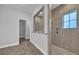 Elegant bathroom with a glass-enclosed shower, tiled walls, and a view into a walk-in closet at 537 Indigo Bay Circle, Myrtle Beach, SC 29579