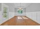 Bright dining room with natural light, wood floors, wainscoting, and stylish light fixture at 537 Indigo Bay Circle, Myrtle Beach, SC 29579