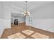 Sunlit dining room features wood floors, wainscoting, and a modern chandelier at 537 Indigo Bay Circle, Myrtle Beach, SC 29579