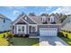 Charming single-story home featuring a well-manicured lawn and a beautiful blue front door at 537 Indigo Bay Circle, Myrtle Beach, SC 29579
