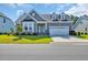 Charming single-story home featuring a well-manicured lawn and a beautiful blue front door at 537 Indigo Bay Circle, Myrtle Beach, SC 29579