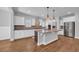 Modern kitchen features an island, white cabinets, stainless steel appliances, and pendant lighting at 537 Indigo Bay Circle, Myrtle Beach, SC 29579
