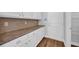 Bright kitchen area with white cabinets, sleek countertops, and wood-style flooring leading to a pantry at 537 Indigo Bay Circle, Myrtle Beach, SC 29579