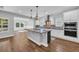 Contemporary kitchen with an island, stylish pendant lights, stainless appliances and white cabinets at 537 Indigo Bay Circle, Myrtle Beach, SC 29579