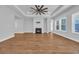 Large living room showcasing a fireplace, tray ceilings, hardwood floors and many windows at 537 Indigo Bay Circle, Myrtle Beach, SC 29579