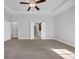 Spacious main bedroom with neutral carpet, tray ceiling, and open doorway to an ensuite bathroom at 537 Indigo Bay Circle, Myrtle Beach, SC 29579