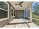 Relaxing screened porch featuring windows, ceiling fan, and wood-look floors, for year-round enjoyment at 537 Indigo Bay Circle, Myrtle Beach, SC 29579