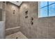 Tiled shower with built-in niche, seat, and glass door; showcasing modern bathroom design at 537 Indigo Bay Circle, Myrtle Beach, SC 29579