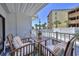 Relax on this charming balcony overlooking the pool with comfortable seating and a cozy atmosphere at 5511 North Ocean Blvd. # 105, Myrtle Beach, SC 29577