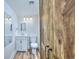 Modern bathroom with a white vanity, wood look flooring, and decorative wood barn door at 5511 North Ocean Blvd. # 105, Myrtle Beach, SC 29577