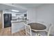 Bright open kitchen with white cabinets, granite countertops, modern appliances, and dining area at 5511 North Ocean Blvd. # 105, Myrtle Beach, SC 29577