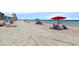 Beautiful beach scene with people relaxing and enjoying the sun at 56 Henderson Way, Pawleys Island, SC 29585