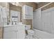 Bathroom with vanity, commode, tub and shower combination, and wallpapered walls at 5751 Oyster Catcher Dr. # 431, North Myrtle Beach, SC 29582
