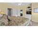 View of bedroom with ensuite bath, ceiling fan, light walls, and wood-look floors at 5751 Oyster Catcher Dr. # 431, North Myrtle Beach, SC 29582
