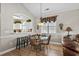 Cozy dining area with modern lighting, a glass table, and a view of the adjacent kitchen space at 5751 Oyster Catcher Dr. # 431, North Myrtle Beach, SC 29582