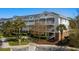 Exterior view of a multi-story condo building with palm trees and lush landscaping at 5751 Oyster Catcher Dr. # 431, North Myrtle Beach, SC 29582