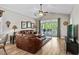Bright and airy living room with vaulted ceilings, plush leather sofa, and sliding glass doors to the patio at 5751 Oyster Catcher Dr. # 431, North Myrtle Beach, SC 29582
