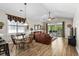 Comfortable living area featuring vaulted ceilings, a leather sofa, wood floors, and patio access at 5751 Oyster Catcher Dr. # 431, North Myrtle Beach, SC 29582
