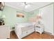 Cozy bedroom features bright green walls, a ceiling fan, and wooden floors at 6001-1592 South Kings Hwy., Myrtle Beach, SC 29575
