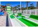 Thrill-seekers gliding down the vibrant green-and-white striped water slide at 6001-1592 South Kings Hwy., Myrtle Beach, SC 29575