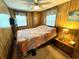 Bedroom featuring wood paneled walls, carpet, and a ceiling fan at 6001-5117 S Kings Hwy., Myrtle Beach, SC 29575