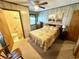 Bedroom featuring floral bedding, wood paneling, and a private bathroom at 6001-5117 S Kings Hwy., Myrtle Beach, SC 29575