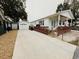 Exterior of a white home with a long driveway and a detached garage at 6001-5117 S Kings Hwy., Myrtle Beach, SC 29575