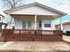 Charming home featuring a cozy front porch with brown wood trim at 6001-5117 S Kings Hwy., Myrtle Beach, SC 29575