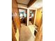 Hallway featuring wood paneling and carpet, with bedroom views at 6001-5117 S Kings Hwy., Myrtle Beach, SC 29575